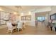 Elegant dining area with an art piece and chandelier, complemented by the natural light from nearby windows at 435 L Ambiance Dr # K506, Longboat Key, FL 34228