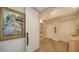 Hallway featuring hardwood floors, decorative painting, and elevator access at 435 L Ambiance Dr # K506, Longboat Key, FL 34228