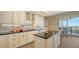Well-appointed kitchen with sleek countertops, modern appliances, and a breakfast nook with balcony access at 435 L Ambiance Dr # K506, Longboat Key, FL 34228