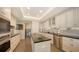 Modern kitchen featuring stainless steel appliances, ample cabinetry, and a convenient center island at 435 L Ambiance Dr # K506, Longboat Key, FL 34228