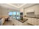 Modern kitchen boasting stainless steel appliances, granite countertops, and a cozy breakfast nook with scenic views at 435 L Ambiance Dr # K506, Longboat Key, FL 34228