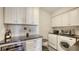 Convenient laundry area with modern appliances, stylish backsplash, and built-in wine storage at 435 L Ambiance Dr # K506, Longboat Key, FL 34228