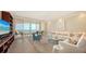 Open living room features ocean views, a comfortable white sofa, and sliding glass doors to balcony at 435 L Ambiance Dr # K506, Longboat Key, FL 34228