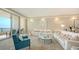 Coastal living room featuring a white sofa, an ocean view, and access to the balcony at 435 L Ambiance Dr # K506, Longboat Key, FL 34228