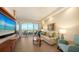 Bright living room featuring a balcony with ocean views and comfortable seating at 435 L Ambiance Dr # K506, Longboat Key, FL 34228