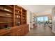 Bright living room featuring custom shelving and scenic views from the expansive windows and private balcony at 435 L Ambiance Dr # K506, Longboat Key, FL 34228