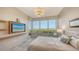 This spacious main bedroom features large windows with serene views, a TV, and an adjacent private balcony at 435 L Ambiance Dr # K506, Longboat Key, FL 34228