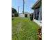 A well maintained backyard features a lush green lawn and a crisp white fence at 4613 Muirfield Dr, Bradenton, FL 34210
