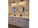 Contemporary bathroom featuring double sinks, modern fixtures, and a clean, bright aesthetic at 4613 Muirfield Dr, Bradenton, FL 34210