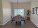 Cozy dining room featuring a round table, modern light fixture, and neutral decor at 4613 Muirfield Dr, Bradenton, FL 34210