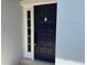 Close-up of a navy blue front door with classic hardware and textured wall at 4613 Muirfield Dr, Bradenton, FL 34210