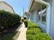 Well-maintained property with green bushes lining a walkway and ample sunlight at 4613 Muirfield Dr, Bradenton, FL 34210