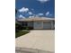 Charming single-story home showcasing a well-manicured lawn, clean driveway, and a neutral color palette at 4613 Muirfield Dr, Bradenton, FL 34210