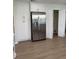 Well-lit kitchen boasting stainless steel refrigerator, white cabinetry, and a convenient pantry closet at 4613 Muirfield Dr, Bradenton, FL 34210