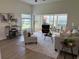 Inviting living room with comfortable seating, neutral color palette, and screened lanai access at 4613 Muirfield Dr, Bradenton, FL 34210