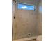 Luxurious walk-in shower with elegant marble tile and modern fixtures for a spa-like experience at 4613 Muirfield Dr, Bradenton, FL 34210