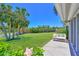 View of backyard with palms and bench overlooking canal and foliage at 4726 Potomac Cir, Bradenton, FL 34210