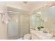 Bathroom featuring a glass-enclosed shower and a vanity with a mirror and decorative accents at 4726 Potomac Cir, Bradenton, FL 34210