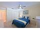 Relaxing bedroom with blue bedspread, white dresser, and ample closet space, perfect for a comfortable retreat at 4726 Potomac Cir, Bradenton, FL 34210