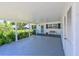 Inviting covered patio area with seating, lush greenery, and a view of the well-maintained landscaping at 4726 Potomac Cir, Bradenton, FL 34210