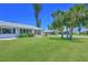 Charming home exterior with a well-kept lawn and mature trees, offering an inviting curb appeal at 4726 Potomac Cir, Bradenton, FL 34210