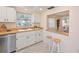 Bright kitchen with white cabinets, wood countertops, and a breakfast bar at 4726 Potomac Cir, Bradenton, FL 34210