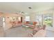 Spacious living room area with neutral carpet, sofas, and open view into the dining area at 4726 Potomac Cir, Bradenton, FL 34210
