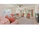 Inviting living room with ceiling fan, striped sofas, and sliding glass doors to the outside at 4726 Potomac Cir, Bradenton, FL 34210