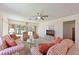 Bright living room featuring comfortable striped sofas, ceiling fan, and large sliding glass doors at 4726 Potomac Cir, Bradenton, FL 34210