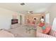 Bright living room featuring comfortable striped sofas, ceiling fan, and open view into the dining area at 4726 Potomac Cir, Bradenton, FL 34210