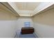 Walk-in closet with shelving and a dark brown storage chest on a carpeted floor at 4726 Potomac Cir, Bradenton, FL 34210
