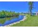 Scenic water view showing tranquil water, lush greenery, and nearby residential buildings under a clear sky at 4726 Potomac Cir, Bradenton, FL 34210