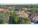Aerial view showcasing the home's location in a mature neighborhood, surrounded by lush trees and well-maintained properties at 4978 Cedar Oak Way, Sarasota, FL 34233