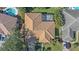 Overhead shot of house showcasing clay tile roof, screened lanai and lush green yard at 4978 Cedar Oak Way, Sarasota, FL 34233
