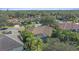 Aerial shot of a home surrounded by lush greenery and other houses at 4978 Cedar Oak Way, Sarasota, FL 34233