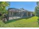 View of the screen enclosed lanai extending to the backyard of the home at 4978 Cedar Oak Way, Sarasota, FL 34233