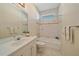 Bright bathroom featuring tiled walls, a tub and shower combo, and a functional vanity at 4978 Cedar Oak Way, Sarasota, FL 34233