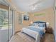 Beautiful staged bedroom with sliding glass doors and tile flooring at 4978 Cedar Oak Way, Sarasota, FL 34233