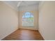 Bedroom features hardwood floors, a ceiling fan, and a window with blinds at 4978 Cedar Oak Way, Sarasota, FL 34233