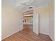 Bedroom with hardwood floors, a ceiling fan, and entry door to other rooms at 4978 Cedar Oak Way, Sarasota, FL 34233