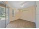 This cozy, sunlit bedroom features sliding glass doors and tile flooring at 4978 Cedar Oak Way, Sarasota, FL 34233