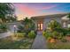 Charming single-story home featuring a red front door, well-maintained landscaping, and an inviting walkway at 4978 Cedar Oak Way, Sarasota, FL 34233
