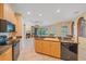 Well-lit kitchen with granite counters and black appliances at 4978 Cedar Oak Way, Sarasota, FL 34233