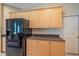 Kitchen featuring granite counters and natural wood cabinets at 4978 Cedar Oak Way, Sarasota, FL 34233