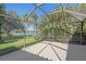 Screened lanai with views of the lake and lush greenery, perfect for relaxing and entertaining at 4978 Cedar Oak Way, Sarasota, FL 34233
