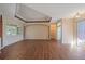 Spacious living room with neutral tones, hardwood floors, tray ceiling and access to the lanai at 4978 Cedar Oak Way, Sarasota, FL 34233