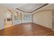 Open living room featuring hardwood floors, decorative tray ceiling, and arched doorways at 4978 Cedar Oak Way, Sarasota, FL 34233