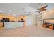 Open living area with kitchen view, built-ins, and tile flooring at 4978 Cedar Oak Way, Sarasota, FL 34233