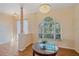 Bright living space with hardwood floors, decorative columns, large windows, and a stylish table at 4978 Cedar Oak Way, Sarasota, FL 34233