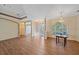 Open floor plan with hardwood floors, tray ceiling, chandelier, decorative columns, and lots of light at 4978 Cedar Oak Way, Sarasota, FL 34233